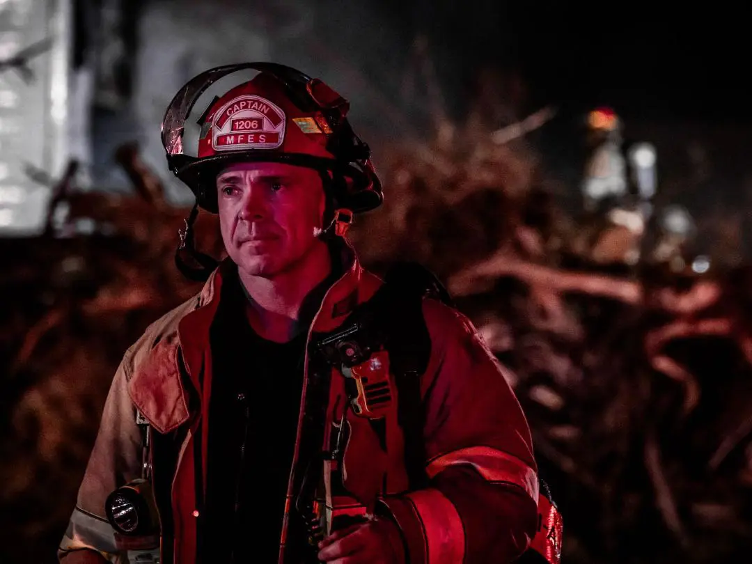 Jarrod2 A fireman in the dark with his helmet on.